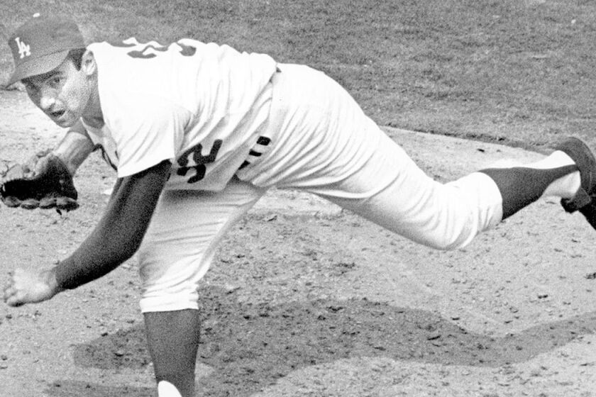 Sandy Koufax pitches in 1965, the year he started and won Game 7 of the World Series on two days' rest.