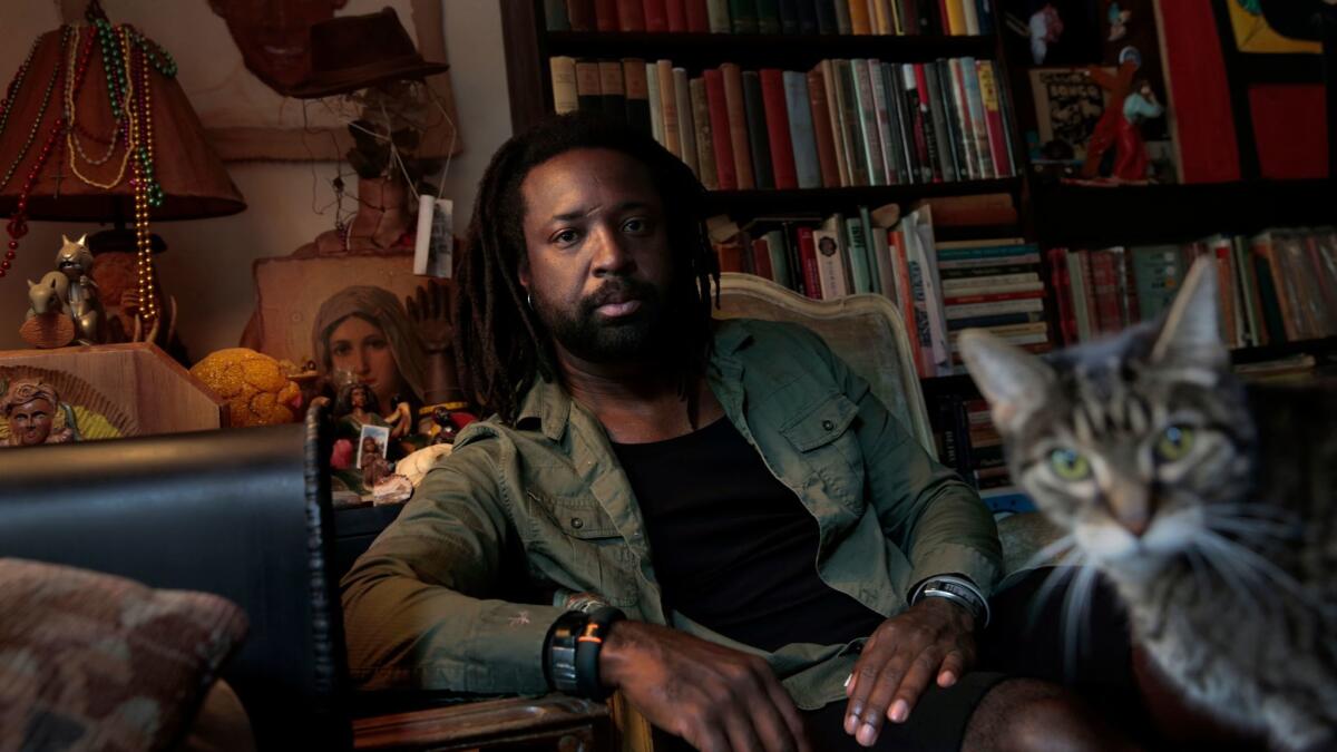 Marlon James being photobombed by a bookstore cat in Harlem.