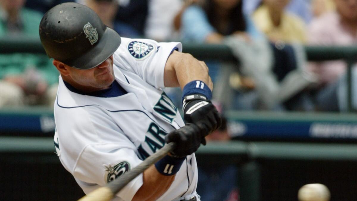 Seattle Mariners designated hitter Edgar Martinez hits a sacrifice fly against the Cleveland Indians in August 2002.