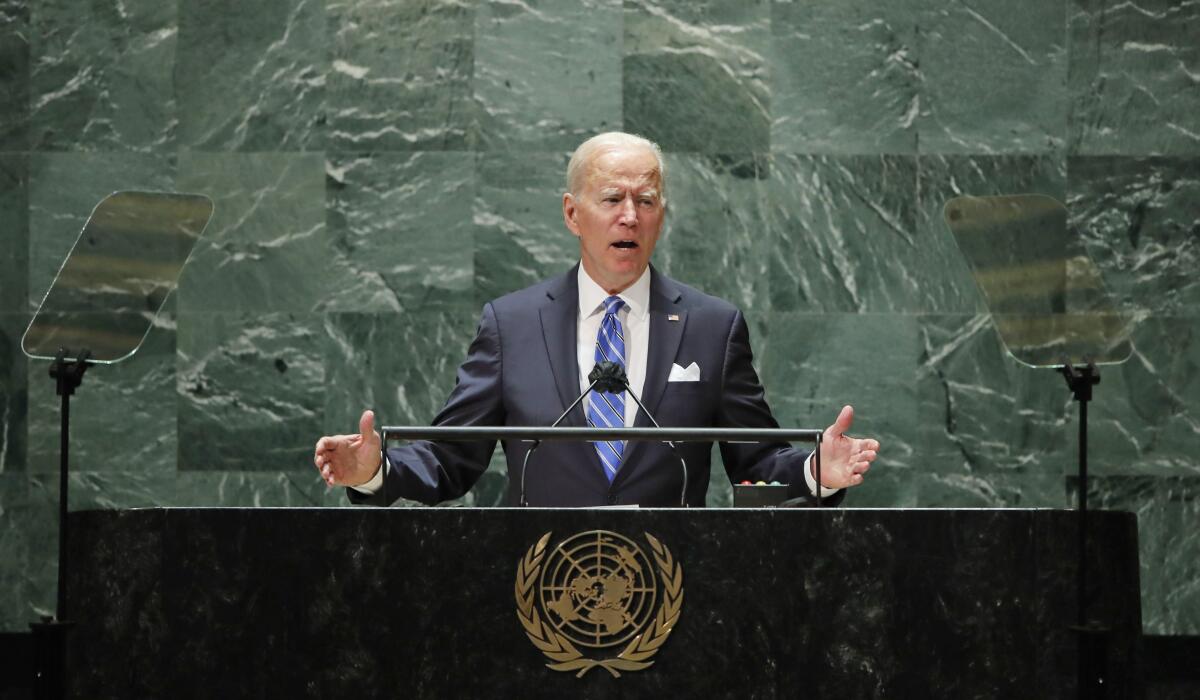 Joe Biden stands at a lectern.