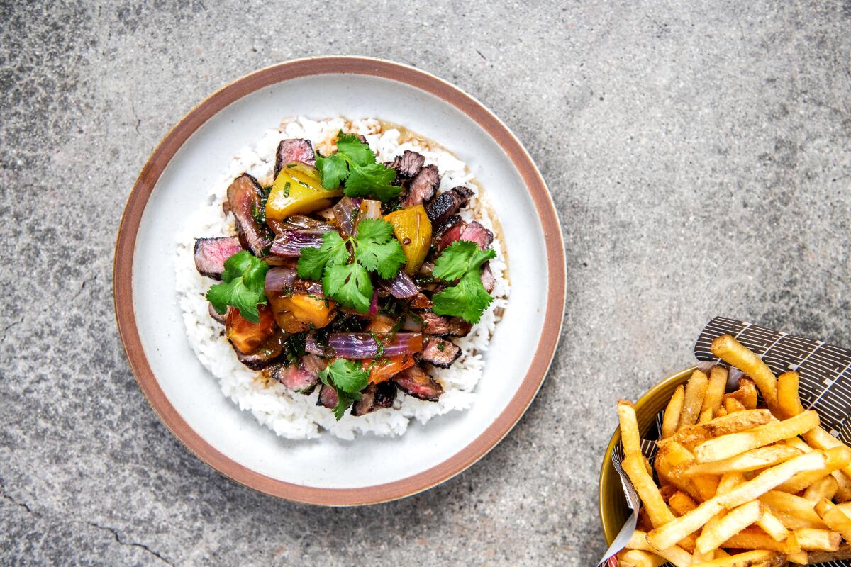 The lomo saltado offers dry aged rib eye steak, rice and very crispy French fries.