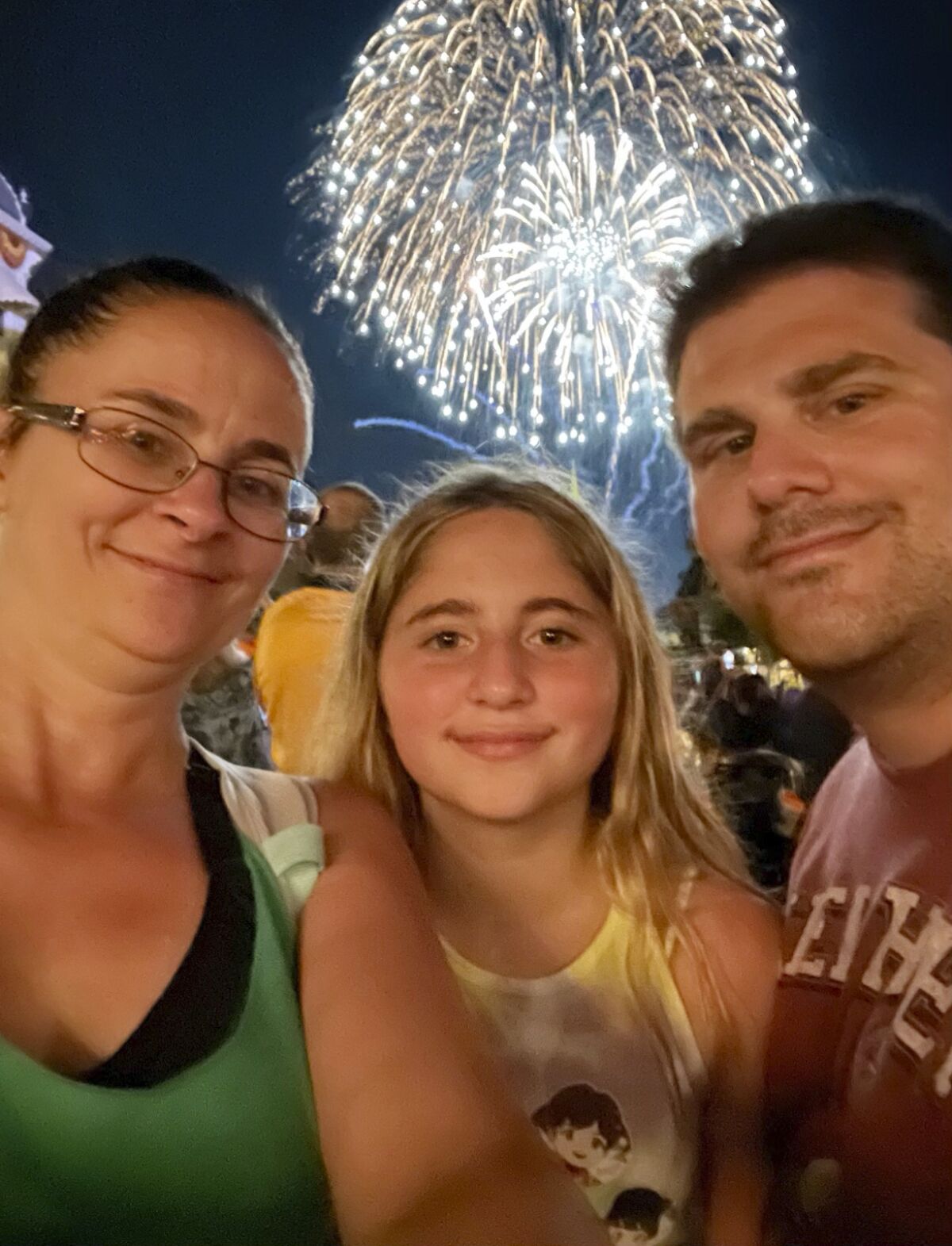 In this image provided by Jennifer Travis, the Travis family, from left, Jennifer, Aubry and Travis pose at Walt Disney World in Orlando, Fla., on Aug. 20, 2021. The family were among hundreds of motorists who waited desperately for help Tuesday, Jan. 4, 2021, after the winter storm snarled traffic and left some drivers stranded for nearly 24 hours along an impassable stretch of Interstate 95 south of the nation’s capital. (Jennifer Travis via AP)