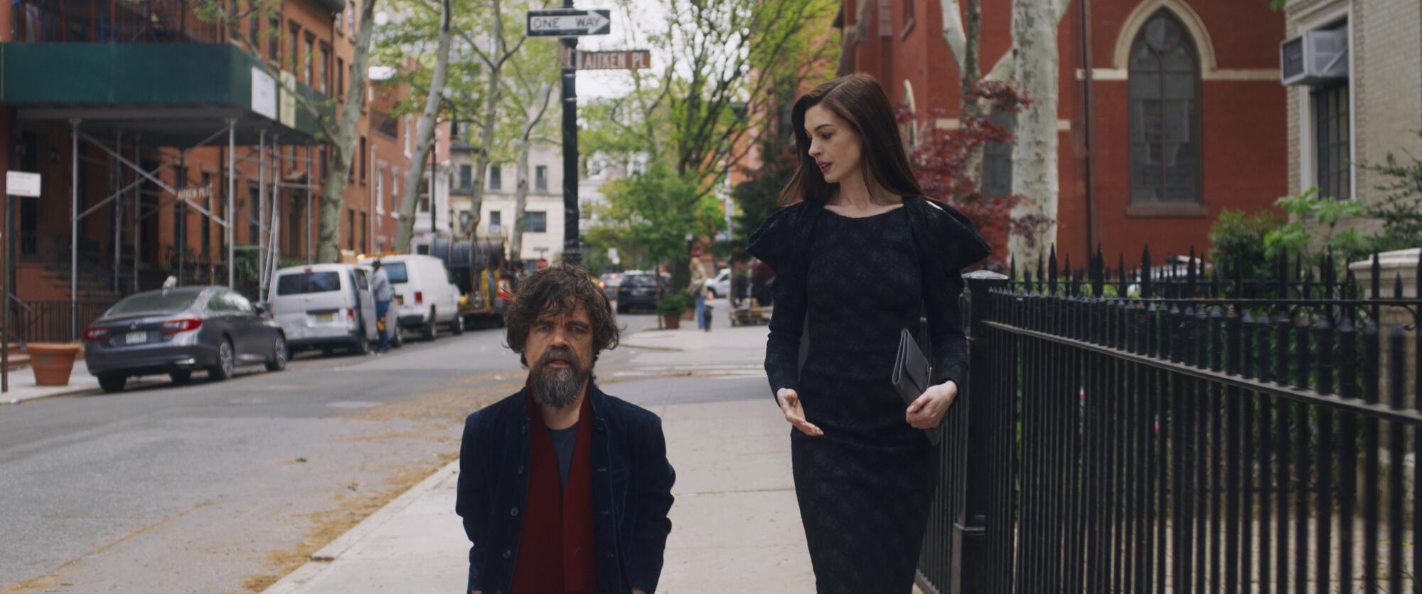 A bearded man and a woman walk down Joralemon St. in Brooklyn Heights.
