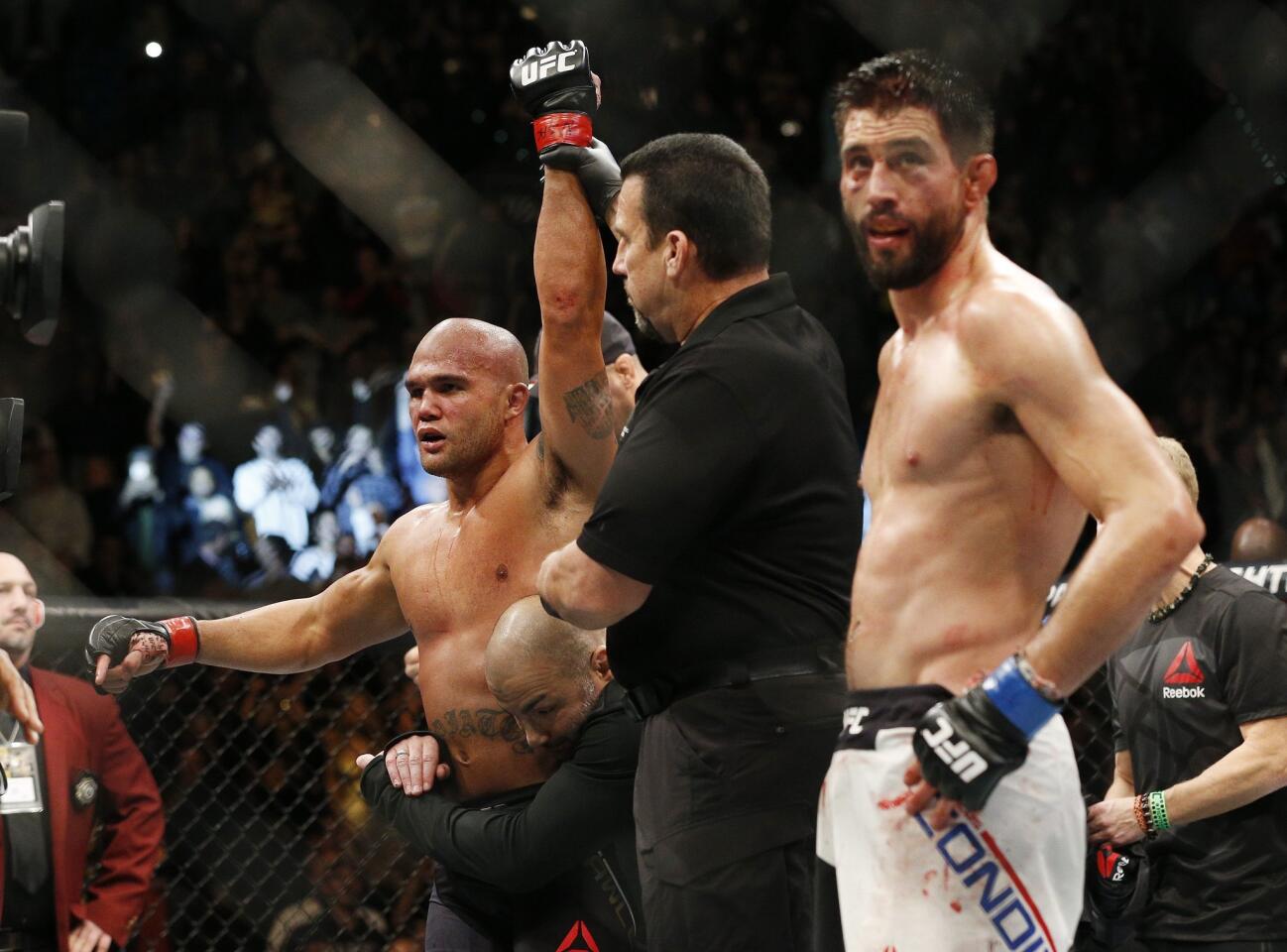 Robbie Lawler, left, celebrates after defeating Carlos Condit during a welterweight championship mixed martial arts bout at UFC 195, Saturday, Jan. 2, 2016, in Las Vegas.