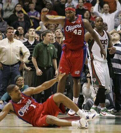 Los Angeles Clippers guard Jason Hart and teammate Elton Brand (42) react in front of Milwaukee Bucks guard Michael Redd after Hart made the game-winning basket in the final seconds.