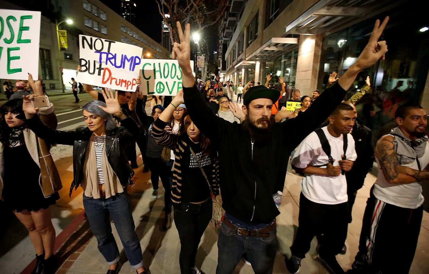 Protesters raise their hands as LAPD officers halt their march through downtown Los Angeles.