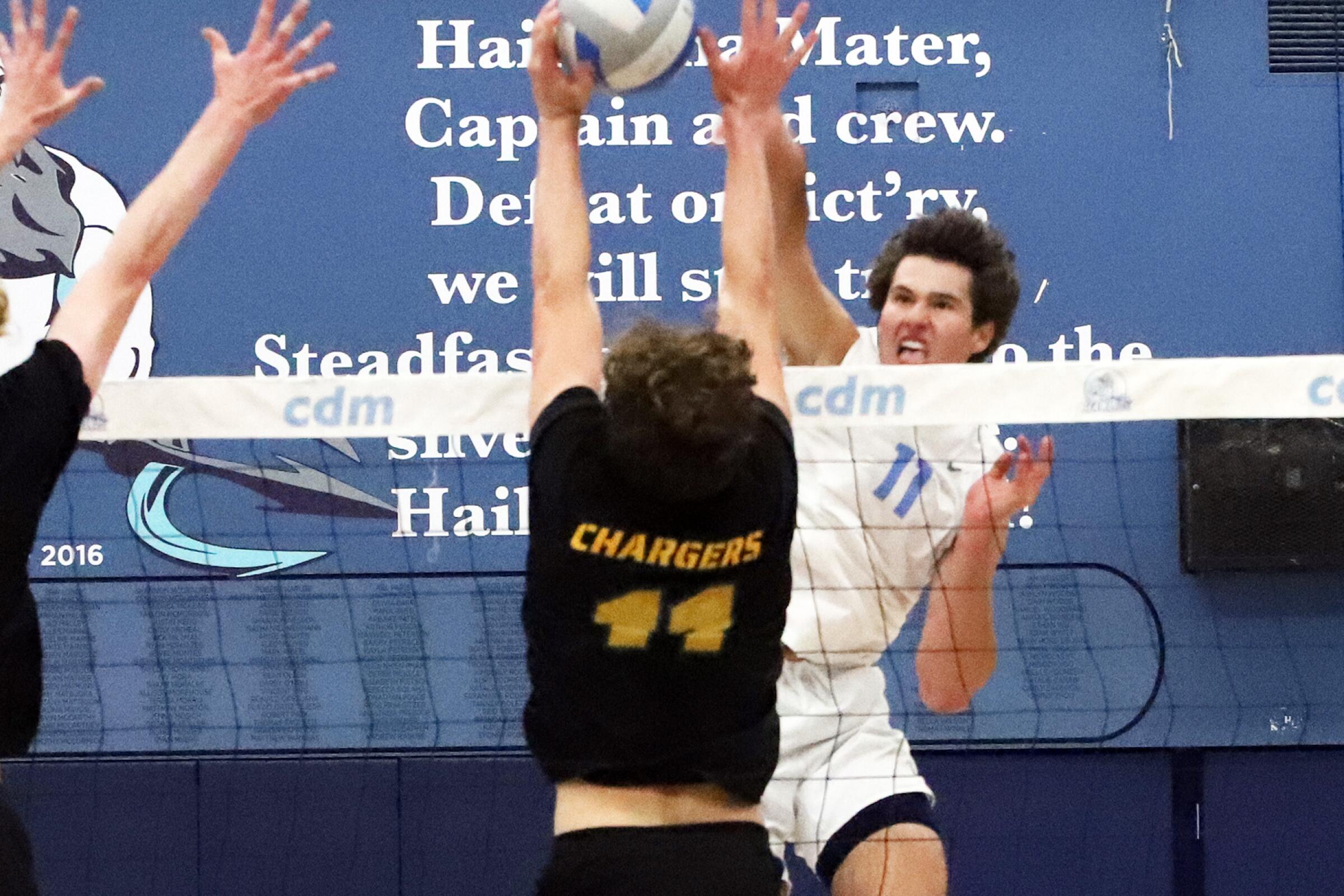Corona del Mar's Sterling Foley (11) spikes past Edison's Connor McNally (11) during Edison High School boys' volleyball team against Corona del Mar High School boys' volleyball team in the CIF Southern Section Division 1 boys' volleyball playoffs at Corona del Mar High School in Newport Beach on Wednesday, April 24, 2024. (Photo by James Carbone)