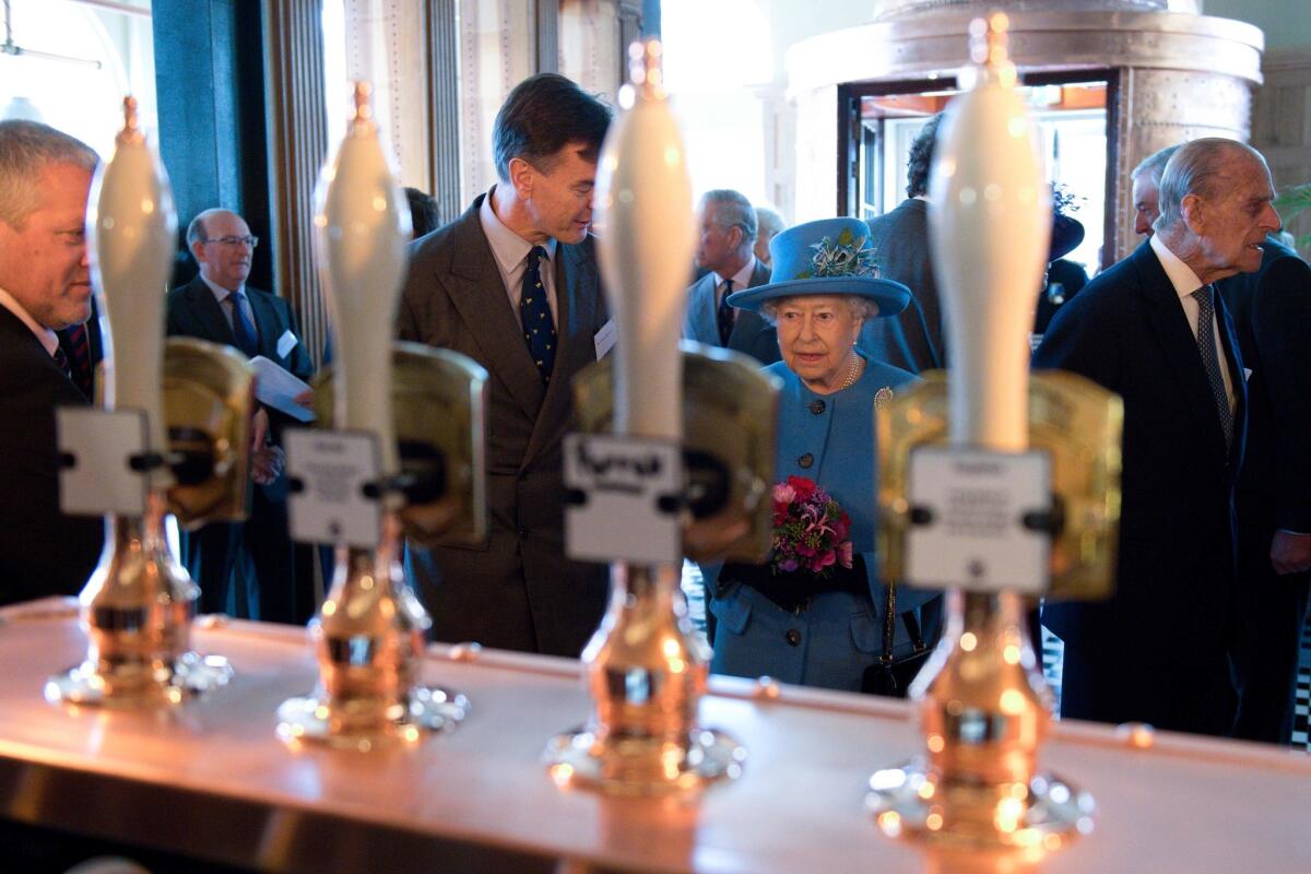 Prince Philip and Queen Elizabeth II stop by the Duchess of Cornwall pub.
