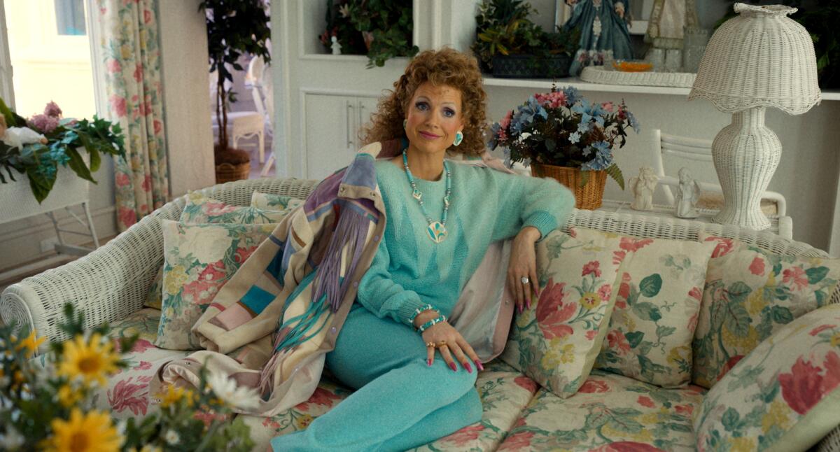 Jessica Chastain wears a matching teal outfit and heavy makeup as the title character in "The Eyes of Tammy Faye."