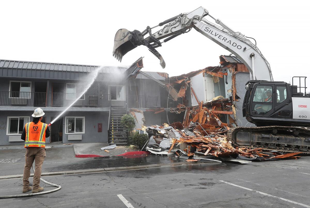Contract workers demolish the former Rainbow Inn as part of Anaheim's "Rebuild Beach" initiative.