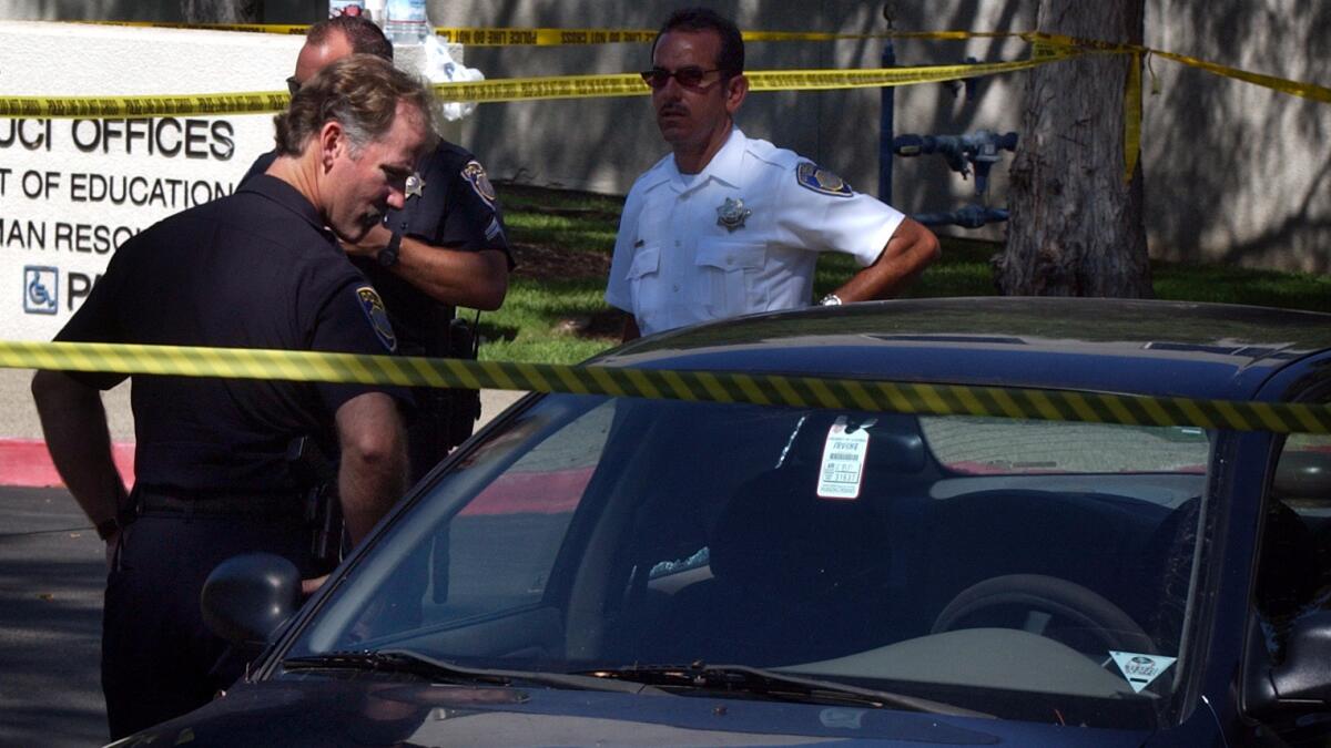 Irvine police investigate the death of an infant found in a car seat inside a parked vehicle at UC Irvine in August 2003.