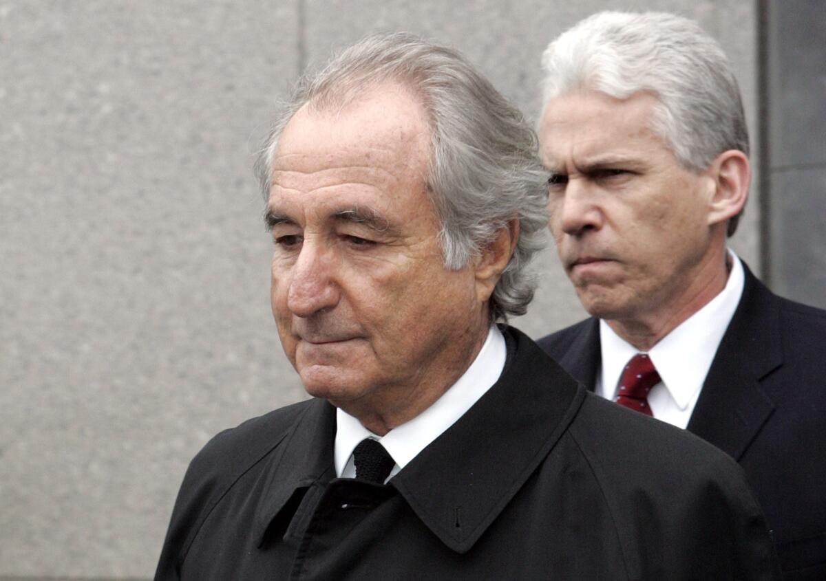 A close-up of Bernie Madoff in 2009 walking out of court ahead of another man