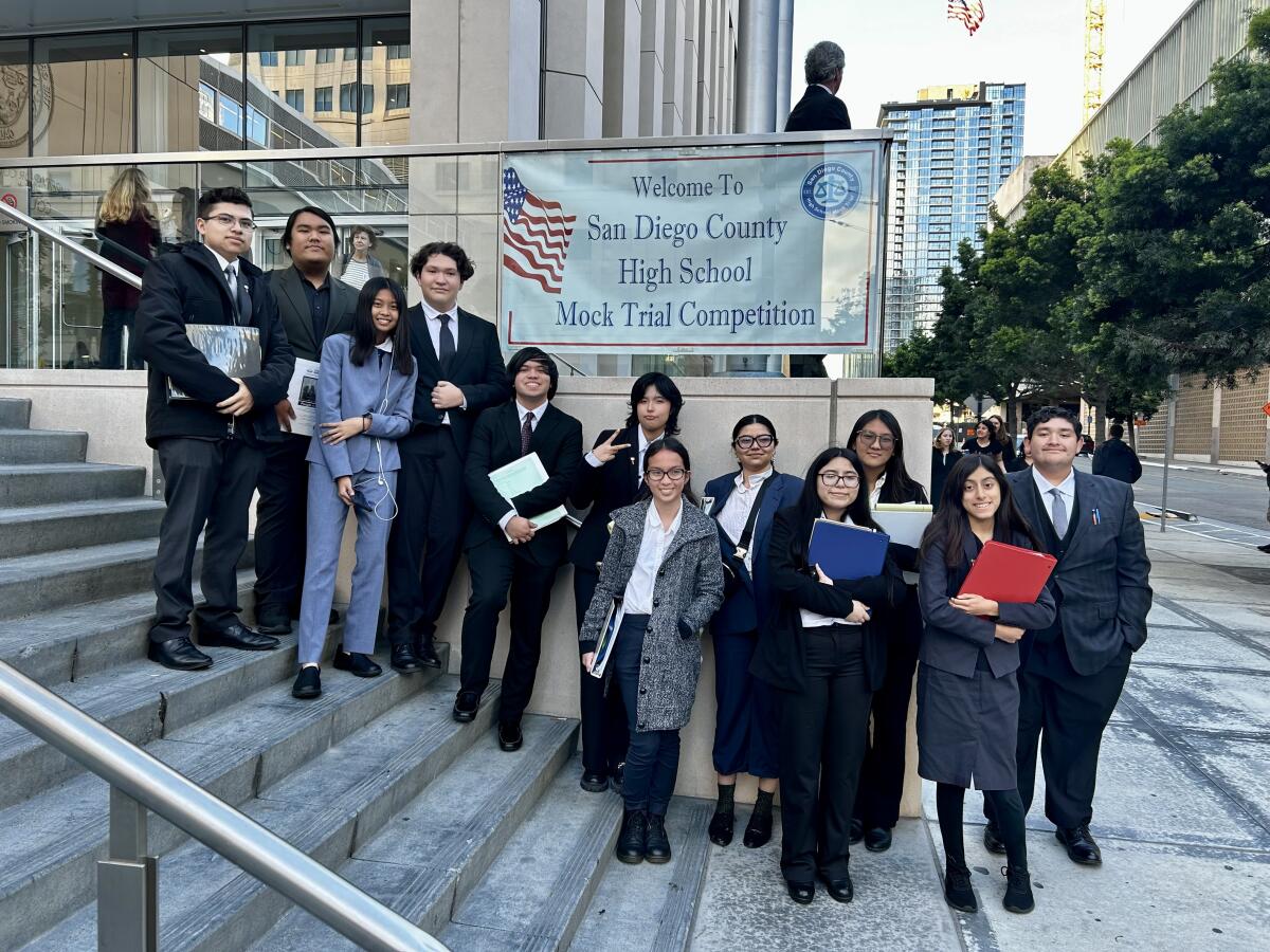 Mock trial student participants stand outside the San Diego Superior Court building on Union Street.