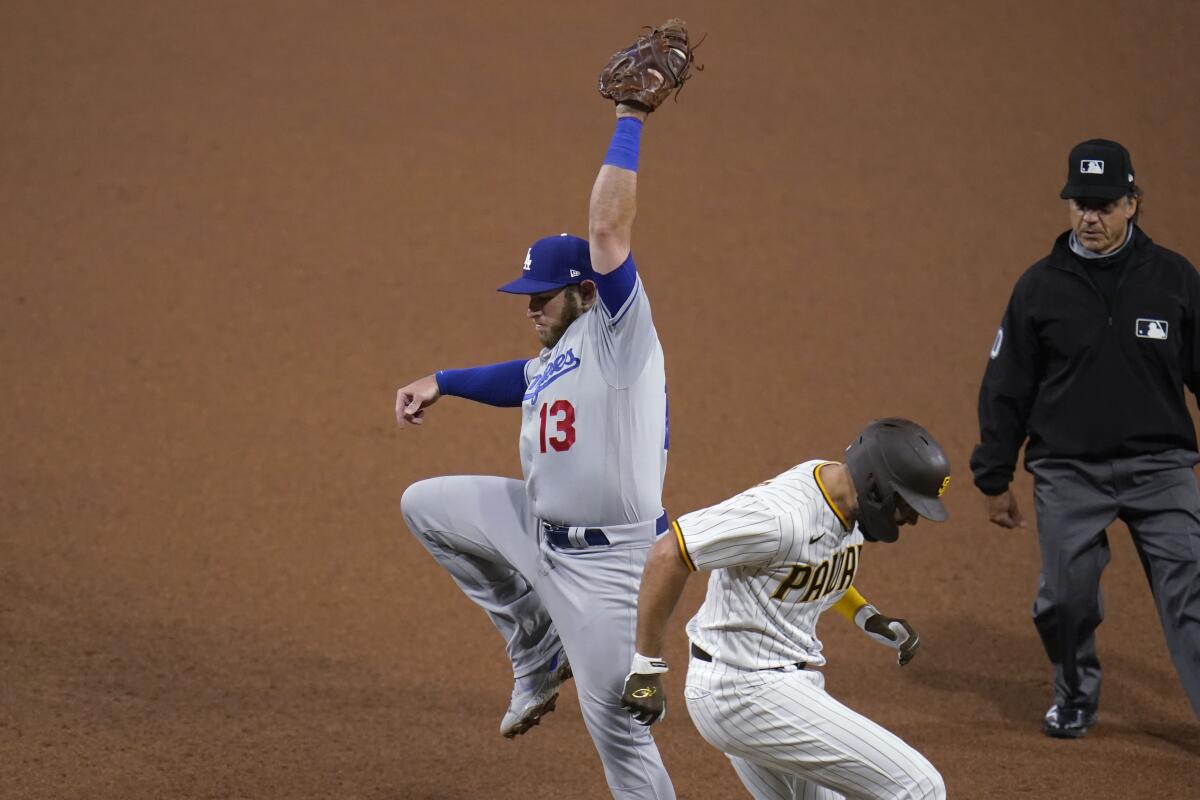 Dodgers first baseman Max Muncy makes a catch to force out San Diego's Eric Hosmer during the eighth inning.