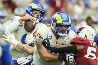 Los Angeles Rams quarterback Matthew Stafford (9) is sacked by Arizona Cardinals linebacker.