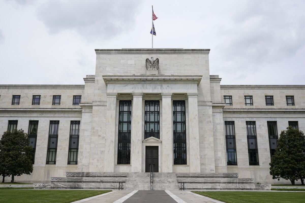 FILE - This May 4, 2021, file photo shows the Federal Reserve building in Washington. The risks to the U.S. financial system have eased significantly compared to a year earlier, the Federal Reserve said Monday, Nov. 8, 2021. (AP Photo/Patrick Semansky, File)