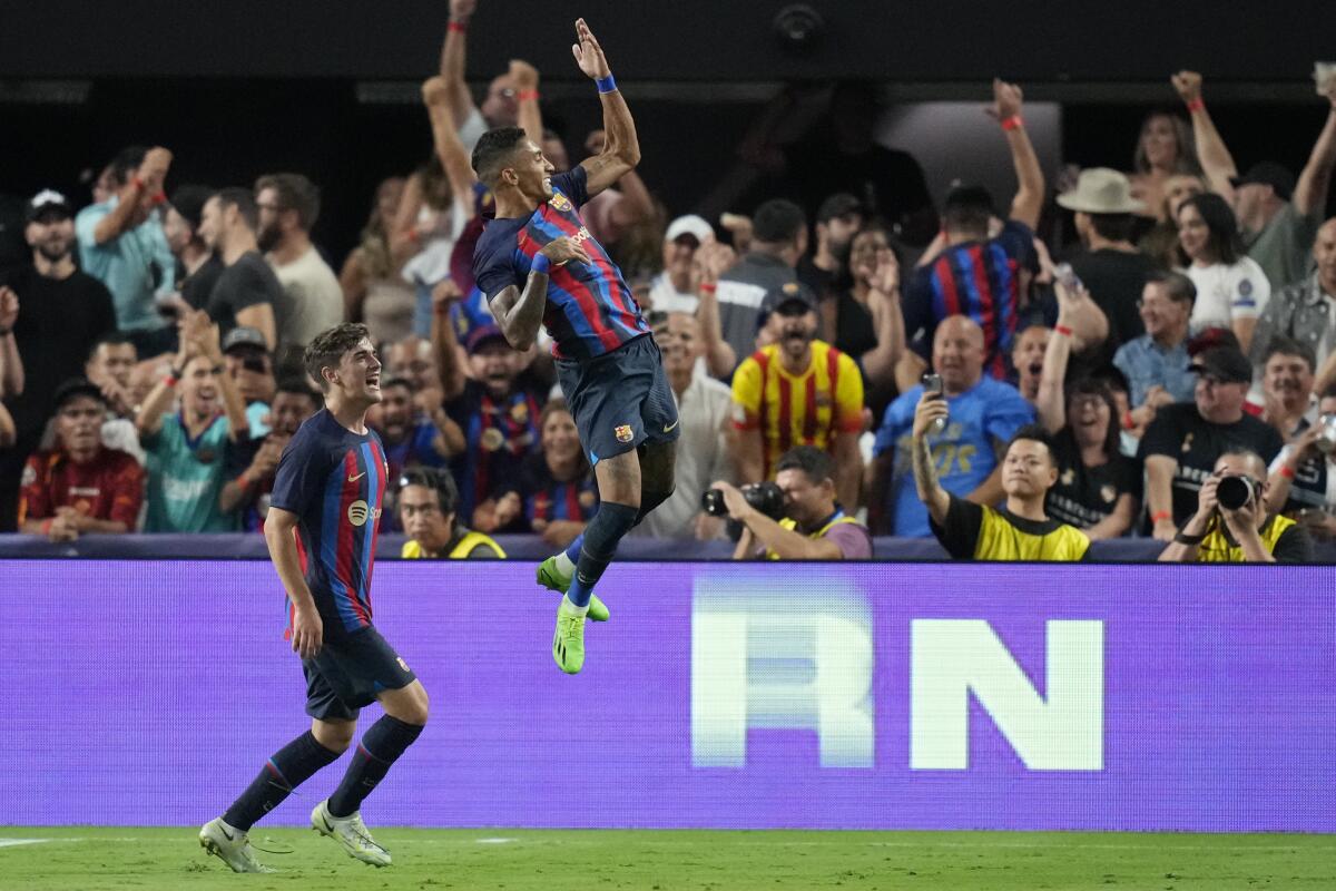 Barcelona's Raphael Dias, right, celebrates after 