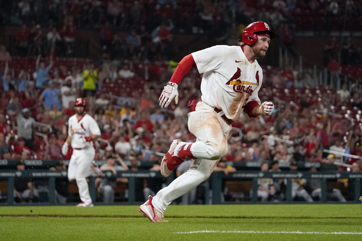St. Louis Cardinals' Brendan Donovan, right, rounds first on his way to a two-run double as Paul Goldschmidt, left, comes in to score during the sixth inning of a baseball game against the Pittsburgh Pirates Monday, June 13, 2022, in St. Louis. (AP Photo/Jeff Roberson)