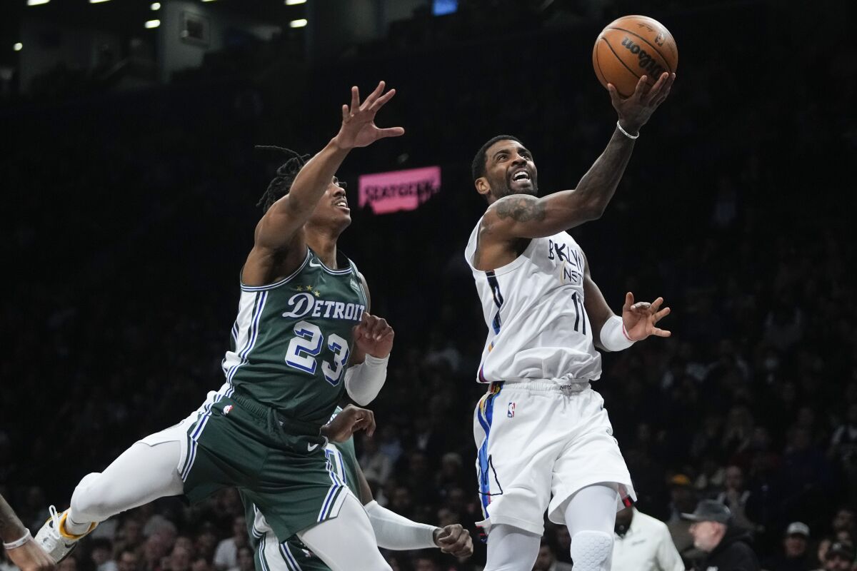 Brooklyn Nets' Kyrie Irving, right, drives past Detroit Pistons' Jaden Ivey during the first half of an NBA basketball game Thursday, Jan. 26, 2023 in New York. (AP Photo/Frank Franklin II)