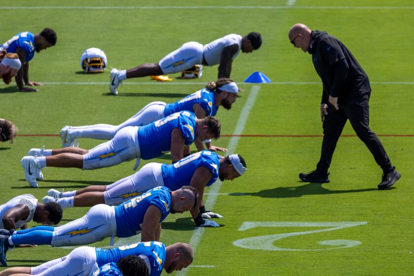 El Segundo, CA - July 24: 5 - A coach belts out instructions as Los Angeles Chargers players.