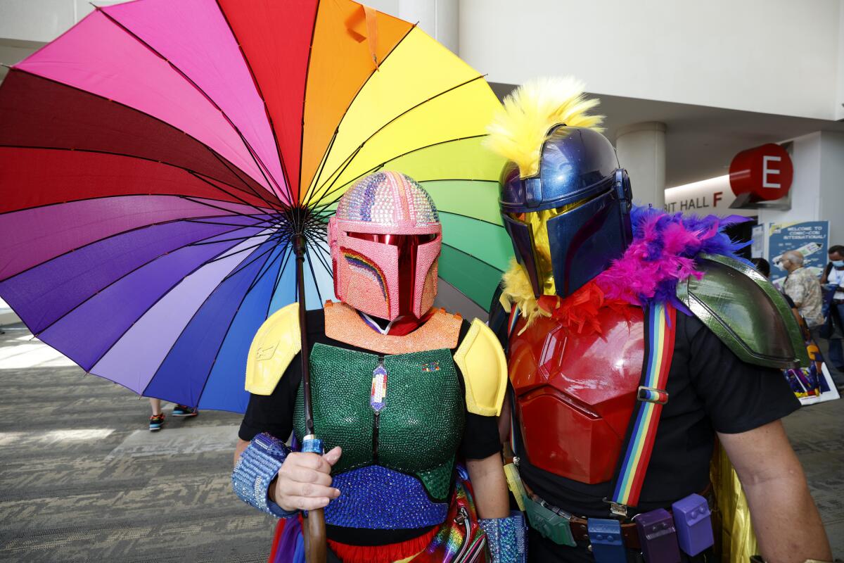 San Diego residents Lisa Lower, left, and Shawn Richter, dressed as Pride Mandalorians, pose on day two on day two of Comic-Con International on Friday, July 22, 2022, in San Diego. (Photo by Christy Radecic/Invision/AP)