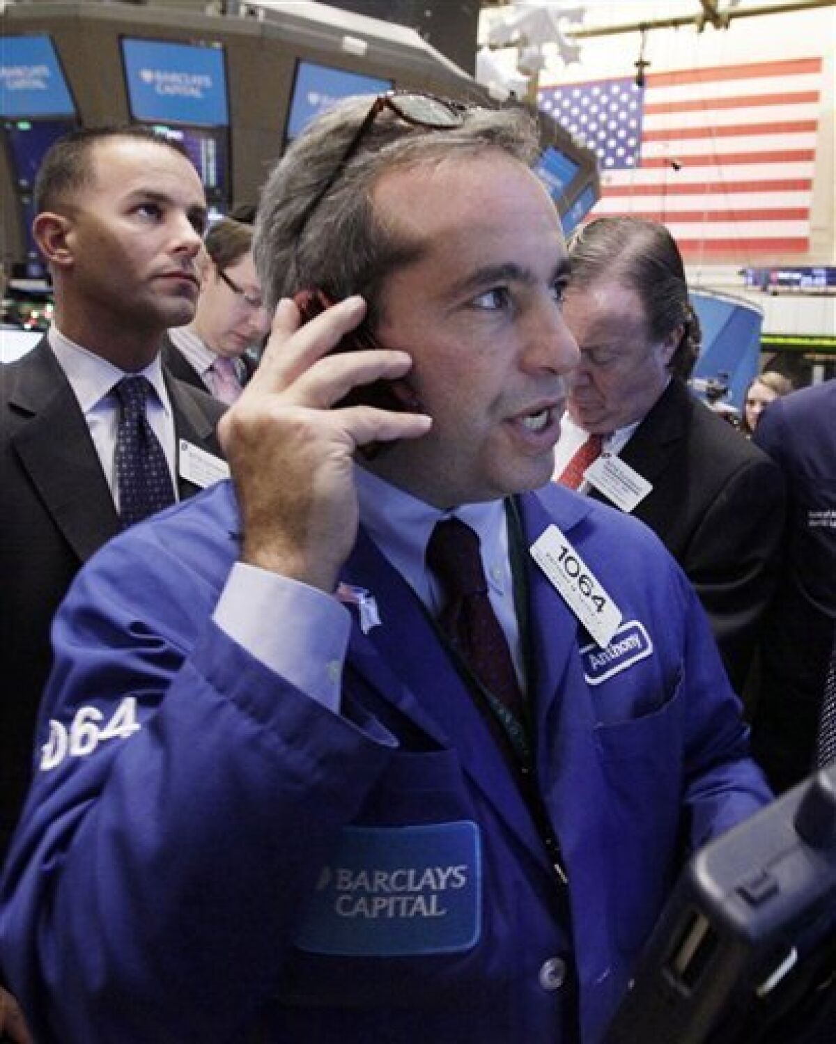 In this Dec. 9, 2011 photo, trader Anthony Satriale, center, works on the floor of the New York Stock Exchange. Enthusiasm for riskier assets such as stocks and the euro faded Monday, Dec. 12, 2011, as investors worried that Europe's new pact aimed at fixing the continent's debt crisis would be insufficient. (AP Photo/Richard Drew)