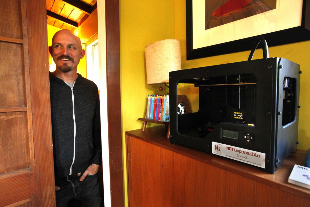 Mick Ebeling with a 3-D printer at the Venice office of Not Impossible. Ebeling, a Hollywood producer, is the group's ideas guy. He comes up with a concept but then leans on others with more expertise to execute it.