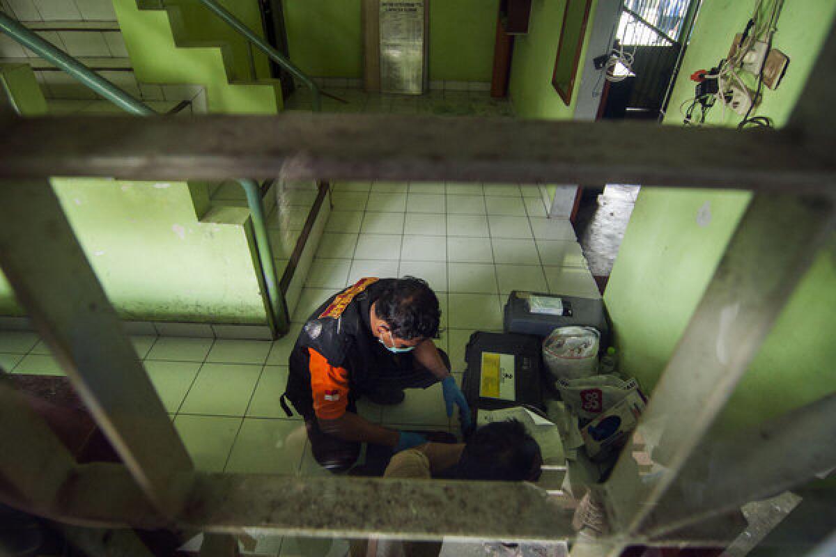 In this March 23 photograph, police investigators inspect the Cebongan Correctional Center after the killing of four prisoners.