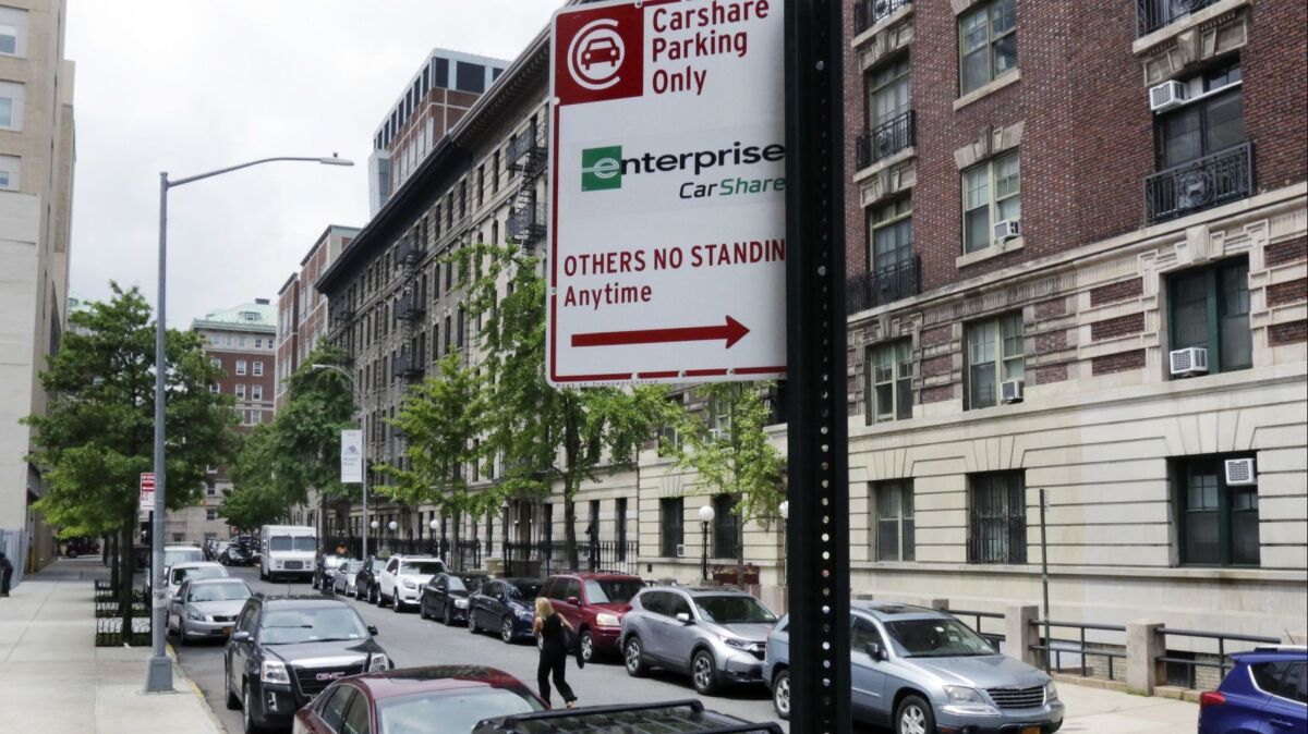 A city sign marks an area in New York's Upper West Side as car share-only zones. New Yorkers are at odds over the new program, saying it takes away needed public parking spots.