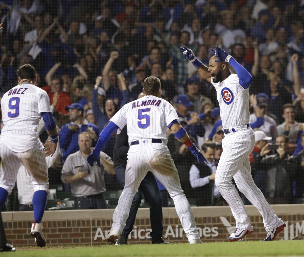 FILE - Chicago Cubs' Jason Heyward, right, celebrates his game-winning grand slam off Philadelphia Phillies relief pitcher Adam Morgan during the ninth inning of a baseball game Wednesday, June 6, 2018, in Chicago. Five-time Gold Glove outfielder Jason Heyward plans to play baseball next season, even if won’t be with the Cubs. Heyward hasn't been in a game since June 24 because of right knee inflammation. Cubs President of Baseball Operations Jed Hoyer said last month that Heyward won't be with Chicago next year. (AP Photo/Charles Rex Arbogast, File)