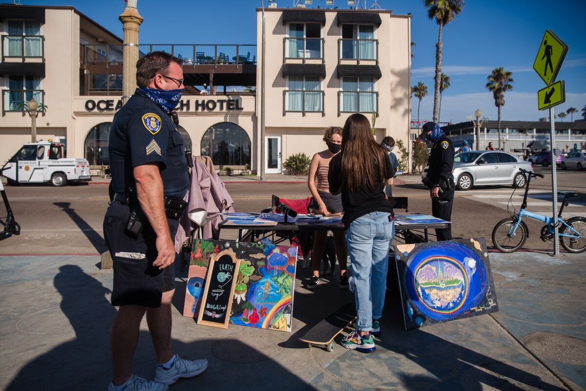 San Diego police patrol near a sidewalk vendor in Ocean Beach in August.