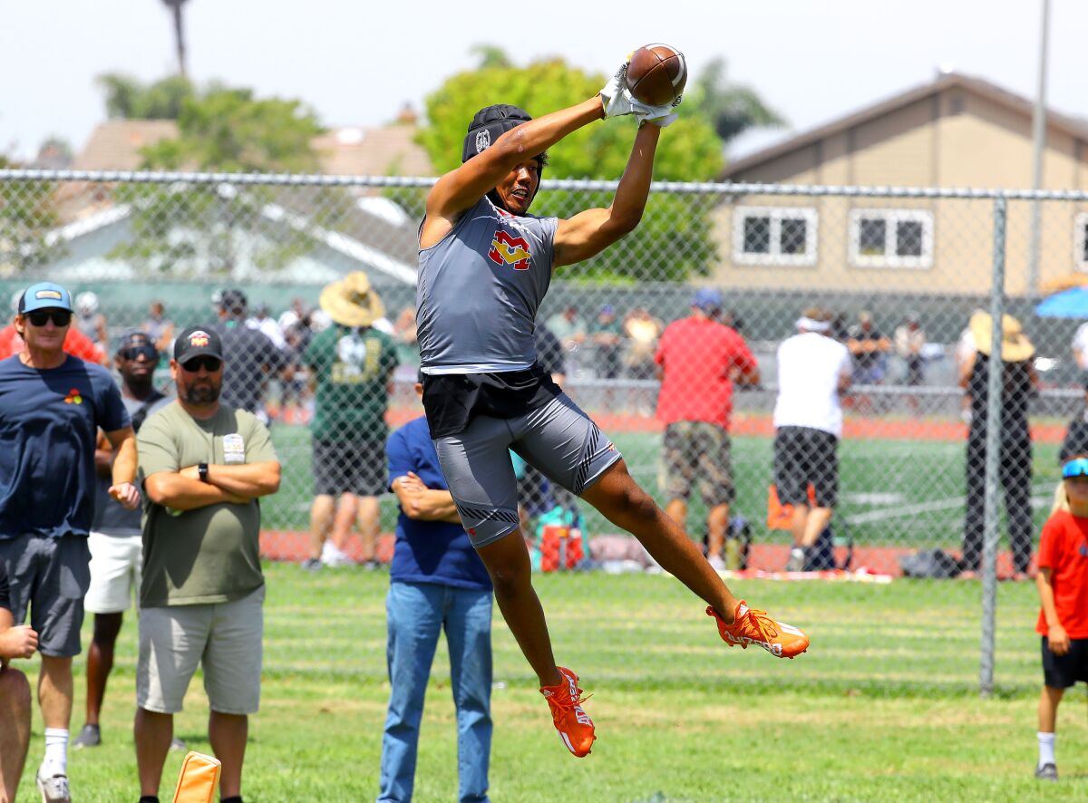 Mikey Matthews leaps to try to make a catch during the Battle at the Beach seven-on-seven passing tournament on July 9.