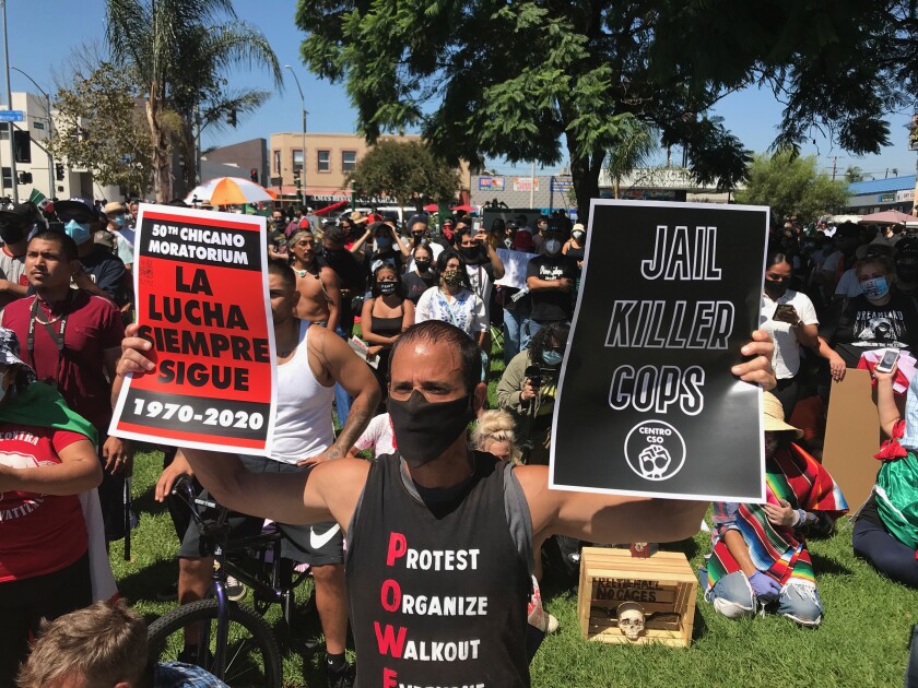 Protesters gather Saturday at Ruben Salazar Park to commemorate the 50th anniversary of the Chicano Moratorium.