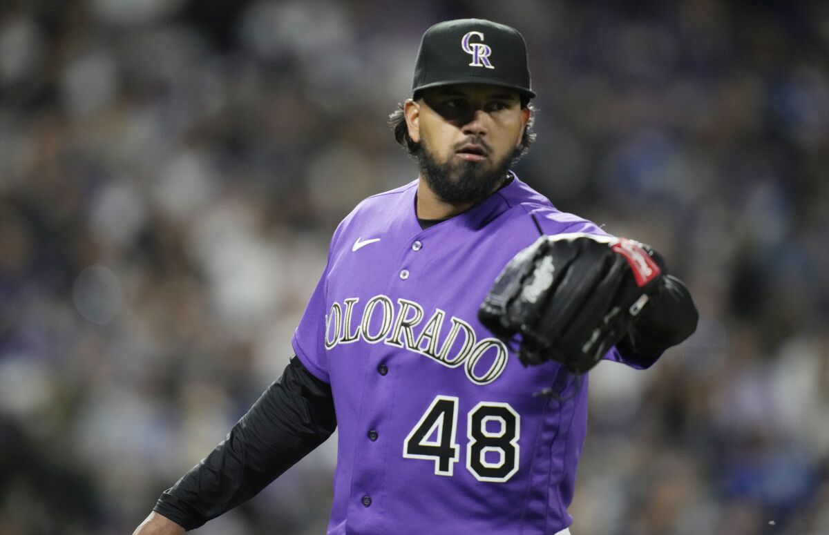 Colorado Rockies pitcher German Marquez is congratulated by a teammate after retiring the Dodgers in the seventh inning.