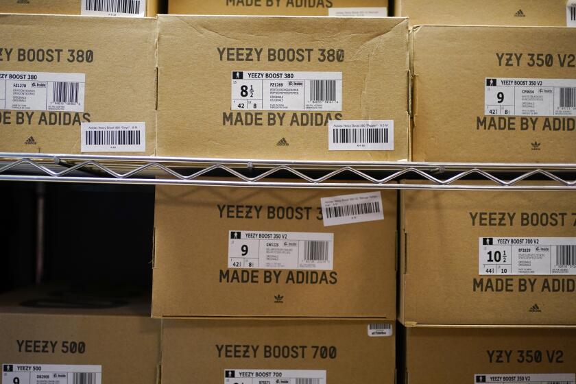 FILE - Boxes containing Yeezy shoes made by Adidas are seen at Laced Up, a sneaker resale store, in Paramus, N.J., Tuesday, Oct. 25, 2022. Adidas saw operating earnings dwindle in the first three months of the year as the German sportswear company's breakup with the rapper formerly known as Kanye West and his popular Yeezy shoe brand cost it 400 million euros ($441 million) in lost sales. Profit was down to 60 million euros from 437 million euros in the same quarter a year ago, while profit margin shrank to a bare 1.1%. Net sales declined 1%, to 5.27 billion euros, and would have risen 9% with the Yeezy line, the company said Friday, May 5, 2023. (AP Photo/Seth Wenig, File)