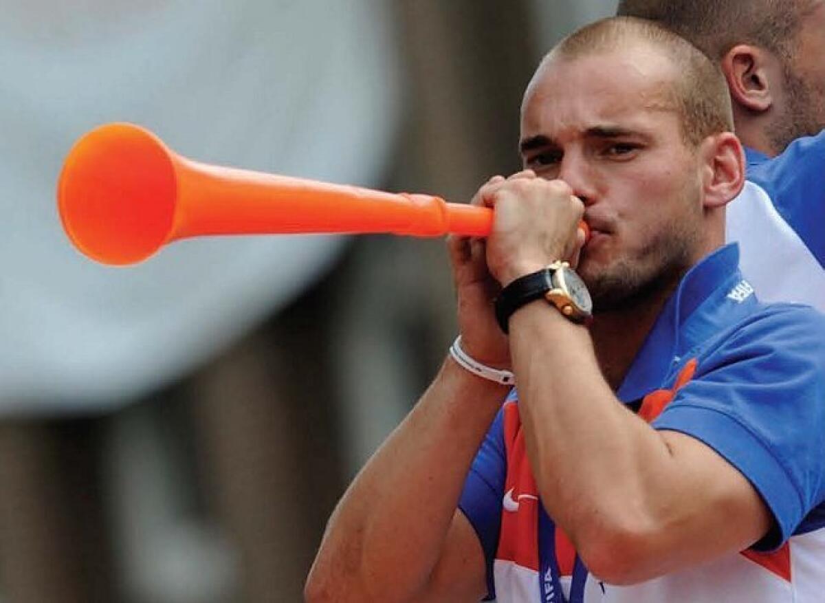 Dutch soccer player Wesley Sneljders plays the vuvuzela during a boat parade in Amsterdam recently.