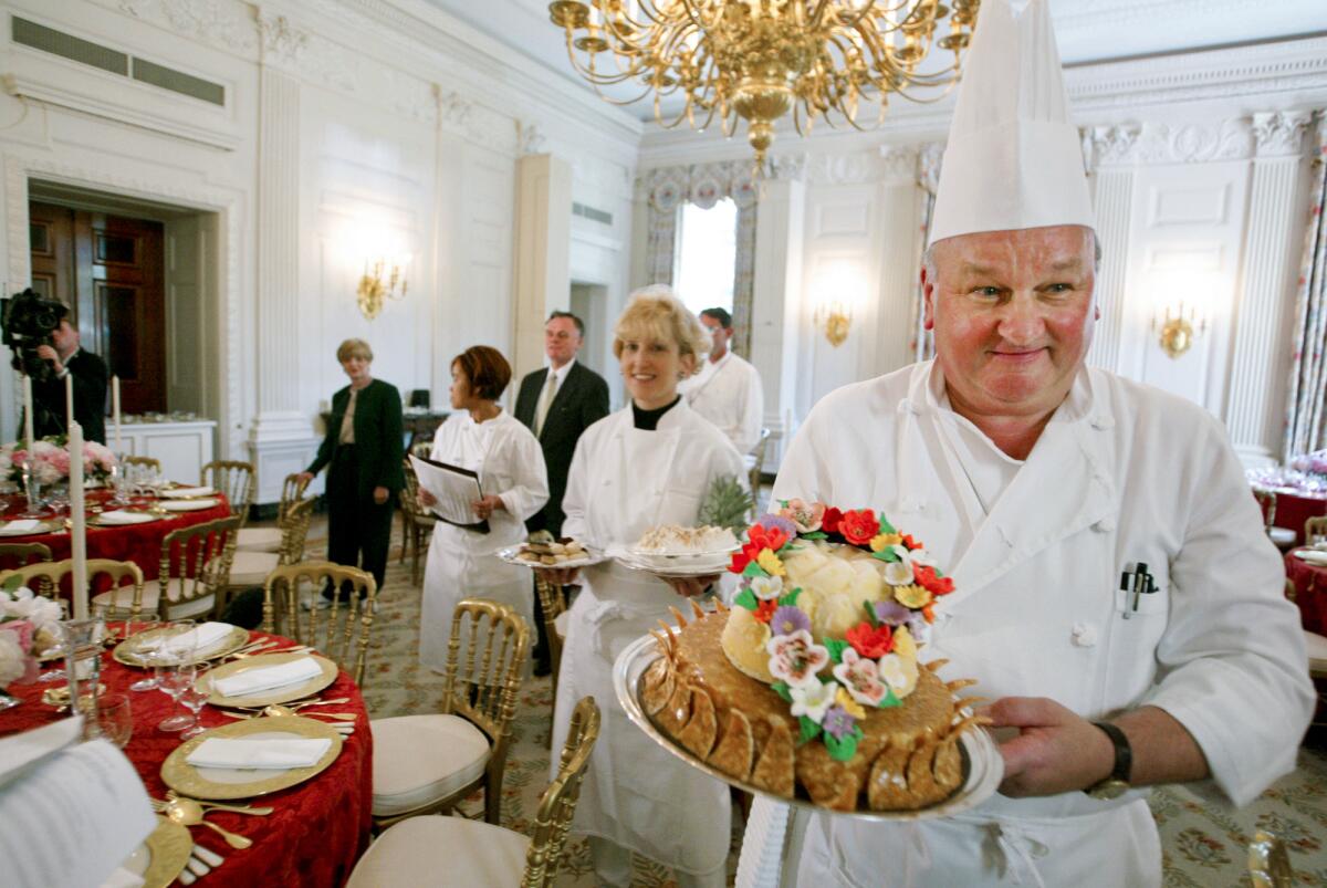 White House pastry chef Roland Mesnier displays a dessert in 2003.