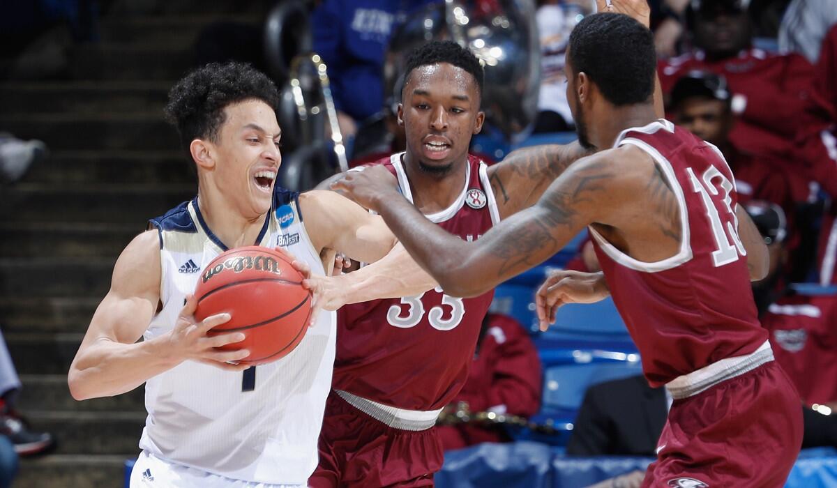 UC Davis' Lawrence White (1) battles for the ball with North Carolina Central's Ron Trapps (33) and Pablo Rivas (13) in the first half during the First Four in the 2017 NCAA Tournament on Wednesday.