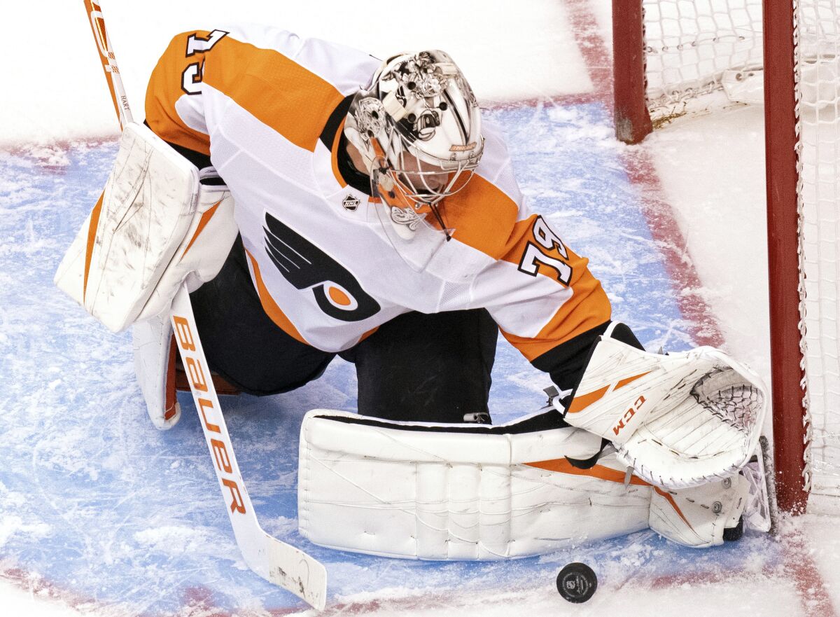 Philadelphia Flyers goaltender Carter Hart (79) makes a save against the Tampa Bay Lightning during the second period of an NHL hockey playoff game Saturday, Aug. 8, 2020, in Toronto. (Frank Gunn/The Canadian Press via AP)