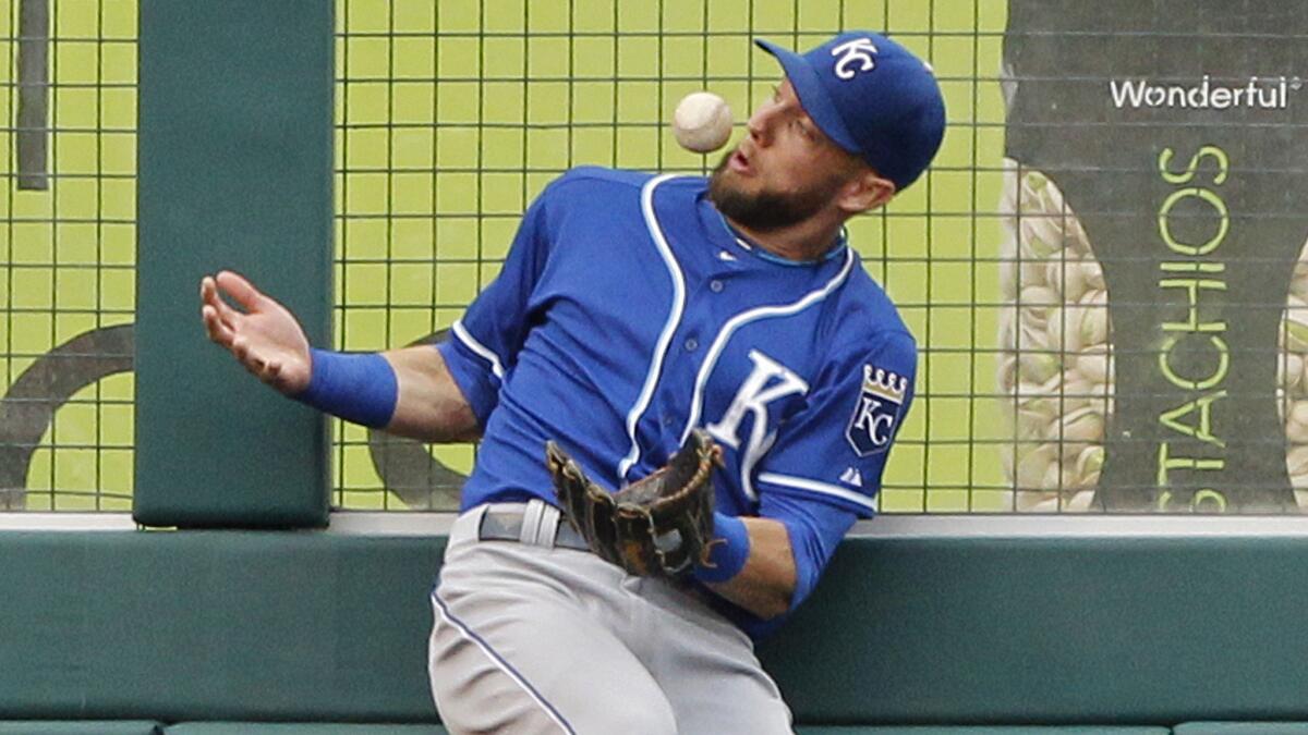 Kansas City Royals left fielder Alex Gordon bobbles a ball hit by Angels slugger Albert Pujols in the fifth inning of the Angels' 7-4 loss in 13 innings Saturday.