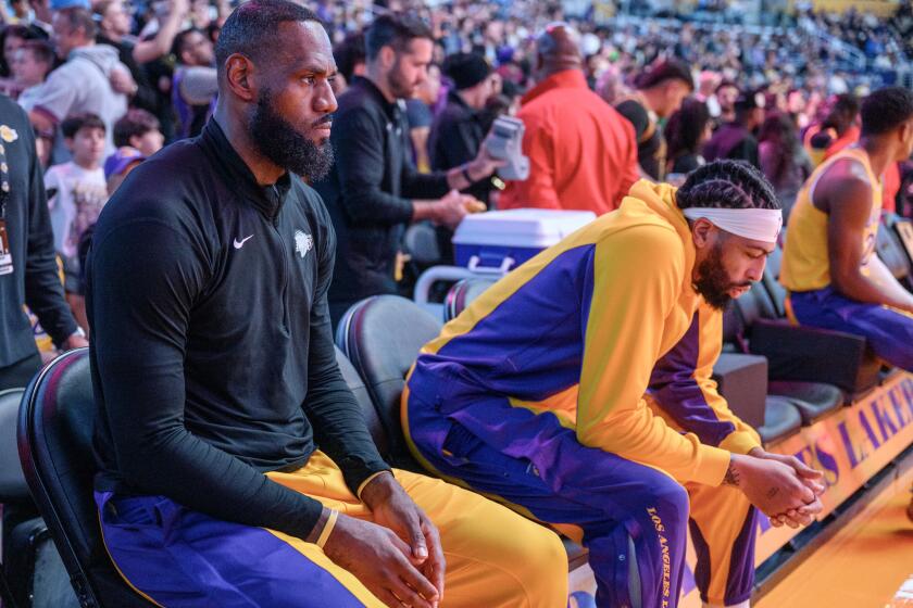 LOS ANGELES, CA - MARCH 18, 2024: Los Angeles Lakers forward LeBron James (23) and Los Angeles Lakers forward Anthony Davis (3) sit on the bench during introductions against the Atlanta Hawks at Crypto.com Arena on March 18, 2024 in Los Angeles, California.(Gina Ferazzi / Los Angeles Times)