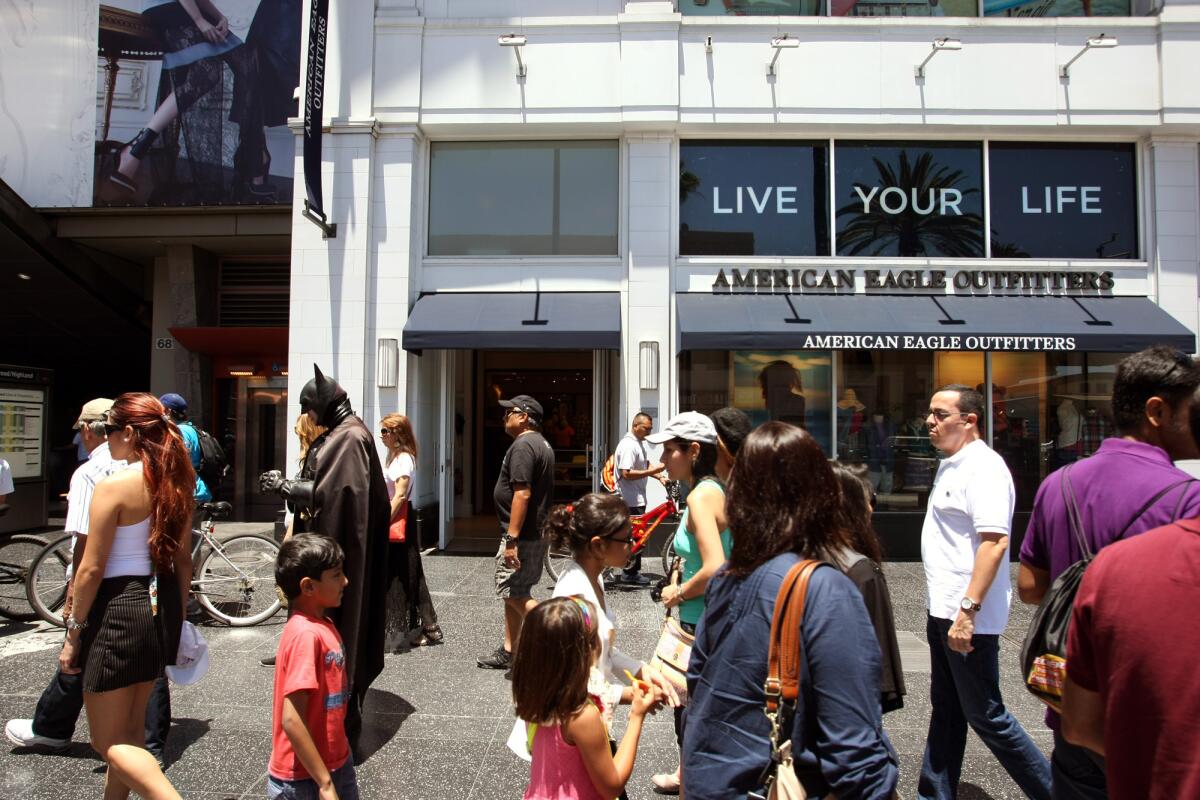 Tourists and other pedestrians make their way past the site where a woman was stabbed along Hollywood Boulevard at the Hollywood and Highland entertainment complex.