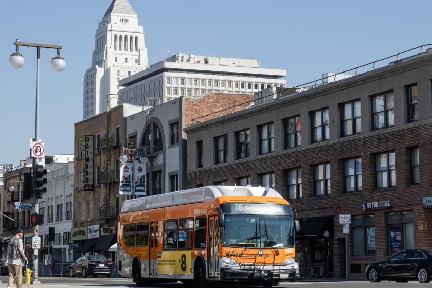 LOS ANGELES, CA - JULY 23: A Metro bus runs on 1st Street through Little Tokyo on Tuesday, July 23, 2024. For 19 straight months, Metro ridership is on the rise hitting over 85 percent of pre-COVID June 2019 levels. (Myung J. Chun / Los Angeles Times)