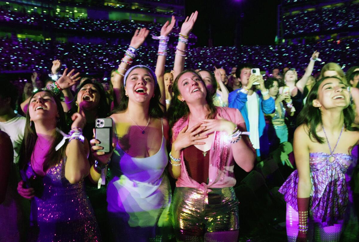 Fans sing along at a Taylor Swift concert.