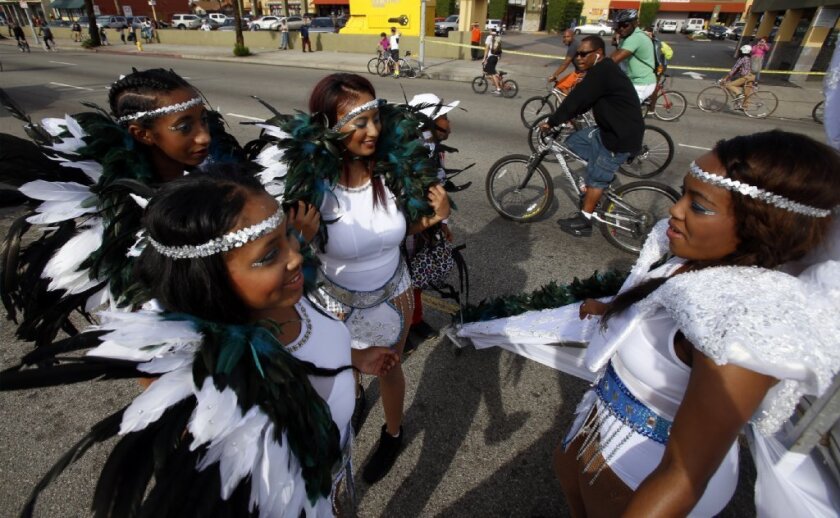 Members of the "Amazon Rebels" dance on Martin Luther King Jr. Boulevard during the 11th CicLAvia bike festival held Sunday in South Los Angeles.
