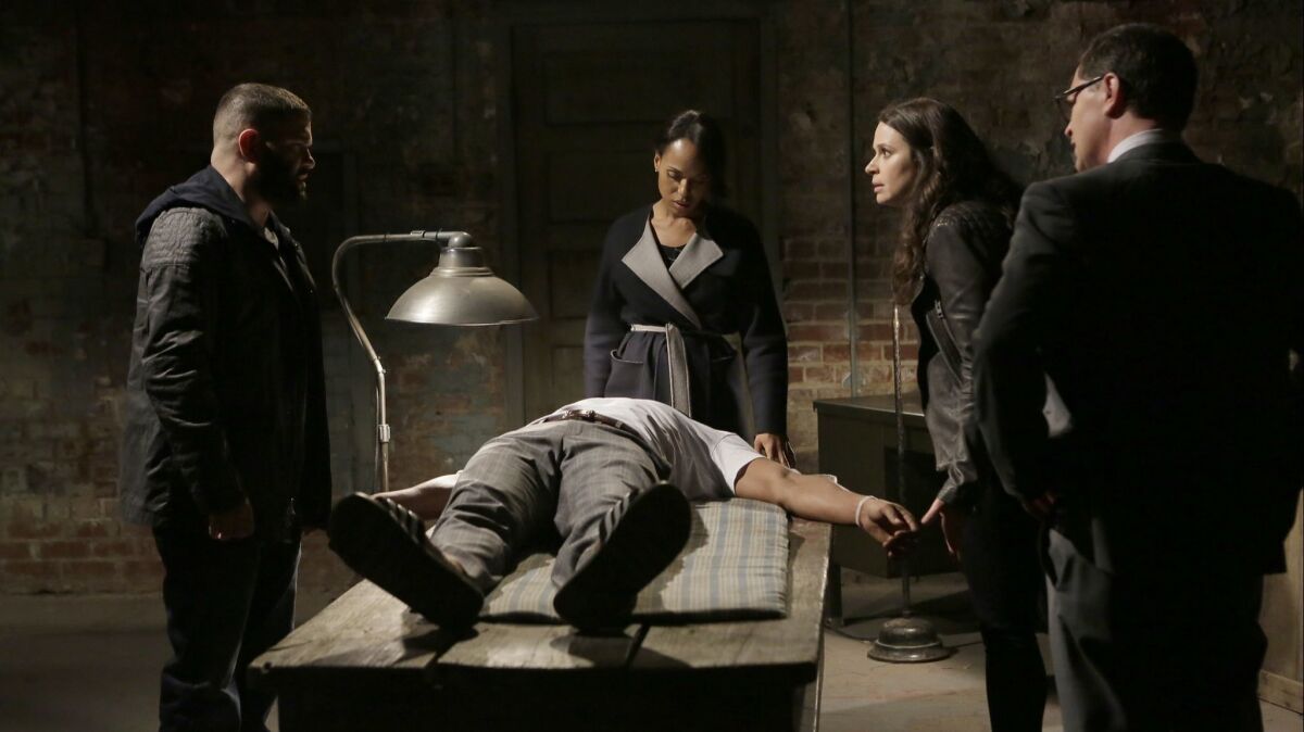 Guillermo Diaz, Scott Foley (on table), Kerry Washington, Katie Lowes and Josh Malina in a scene from "First Lady Sings the Blues" in season 4 of "Scandal."