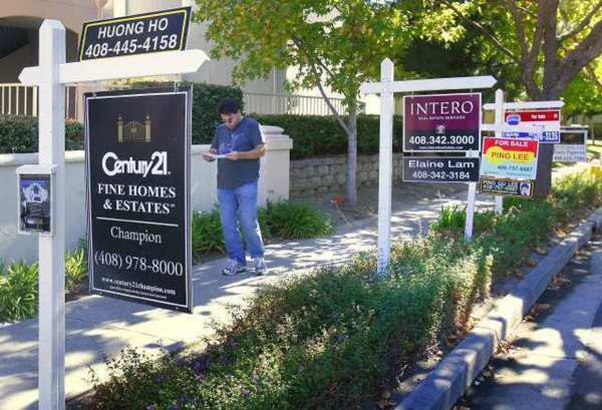 Sales of existing homes improved and prices rose in July, a Realtors group reports. Above, properties for sale in Mountain View, Calif., in 2007.