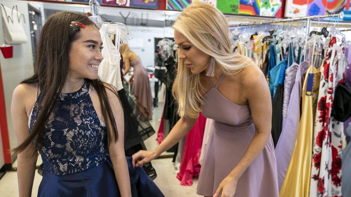Gretchen Rossi, formerly of "The Real Housewives of Orange County," helps Leslie Reyes, 16, find a prom dress at Girls Inc. of Orange County in Costa Mesa on Monday. Estancia High School girls got free prom dresses from Speechless.
