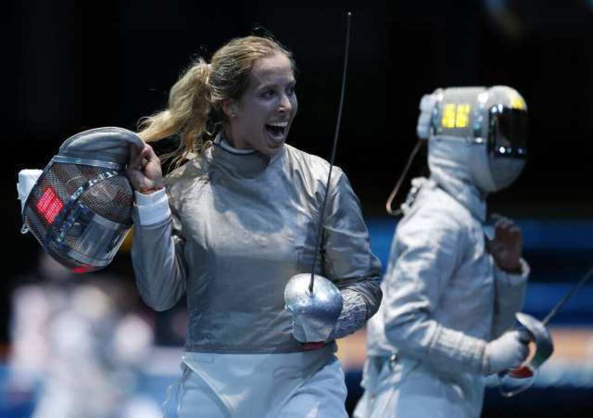 Mariel Zagunis celebrates her victory over China's Min Zhu on her way to the saber fencing semifinals Wednesday.