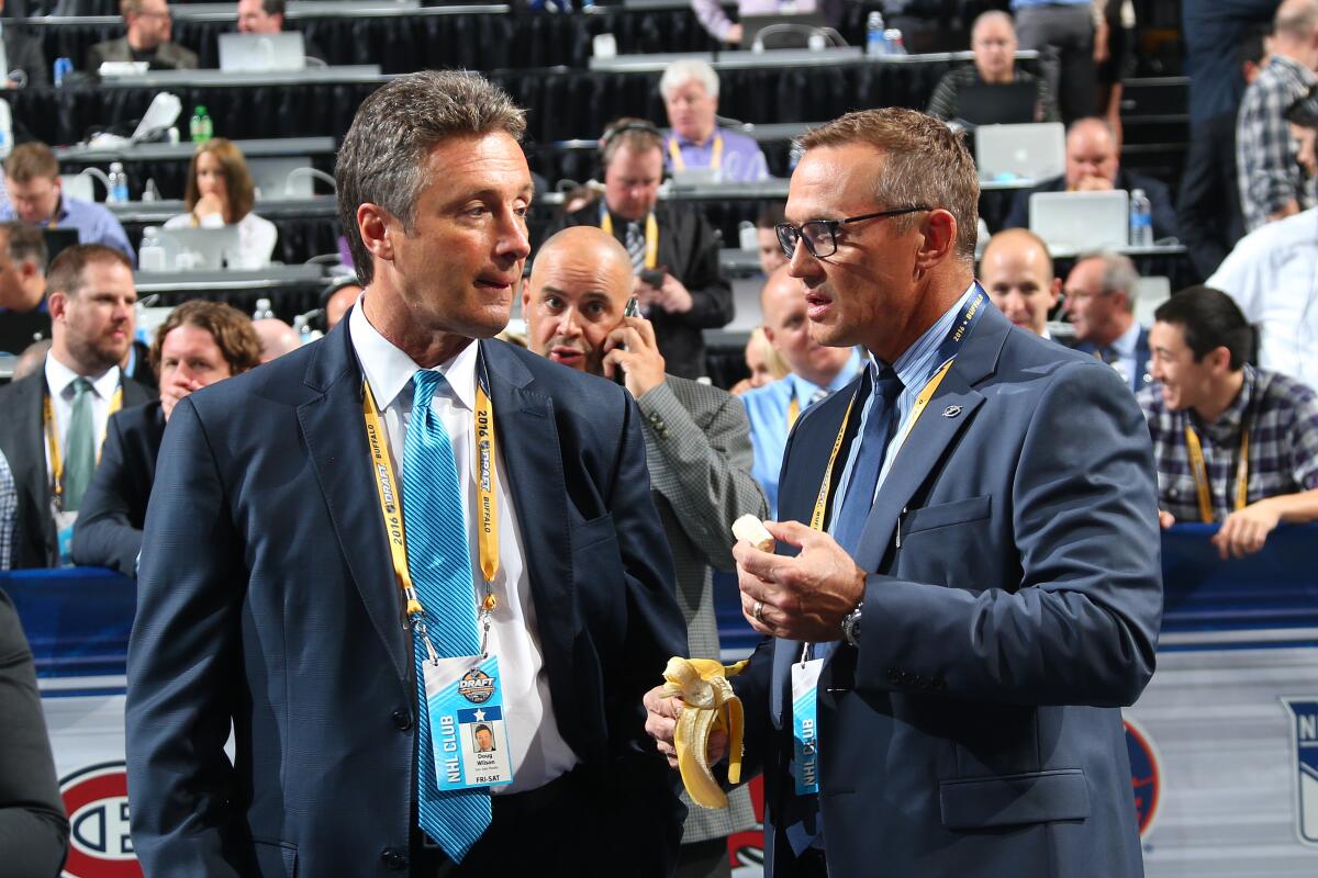 Sharks General Manager Doug Wilson, left, talks to Lightning General Manager Steve Yzerman during the 2016 NHL Draft on June 24, 2016. 